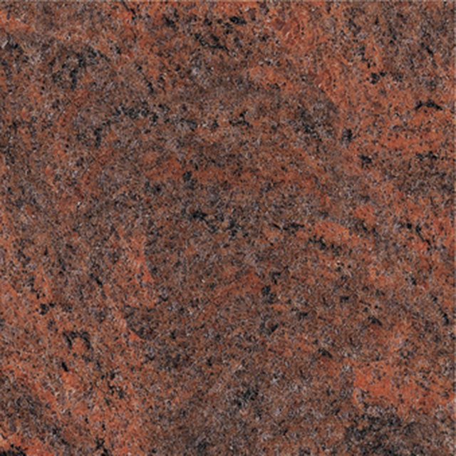A close-up image of red granite, showcasing its natural rough texture and speckled appearance with deep reddish-brown and black mineral deposits. This durable stone is often used for memorials and headstones, embodying strength and timeless beauty.