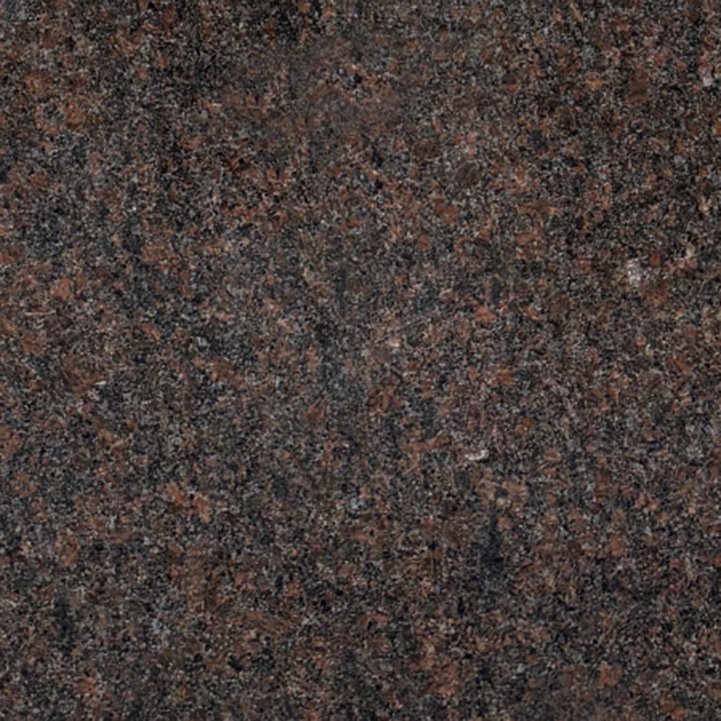 A close-up, high-resolution image of Tan Brown granite, showing its natural, speckled texture with various shades of dark brown, black, and reddish-brown. This image represents the material used for headstones and memorials.
