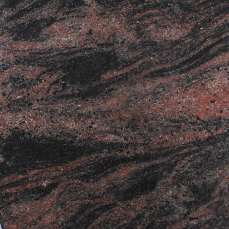 A close-up image of a polished granite surface featuring natural, swirling patterns of dark black and speckled reddish-brown. The organic lines flow dynamically, creating a sense of depth and natural beauty suitable for memorial engraving.