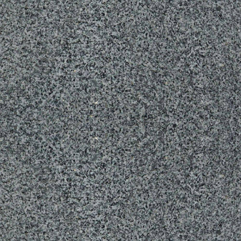A close-up image of a fine-grained granite surface, exhibiting a uniform speckled pattern of various shades of gray, black, and white. This natural stone texture is commonly used for headstones and memorials, representing durability and timelessness.