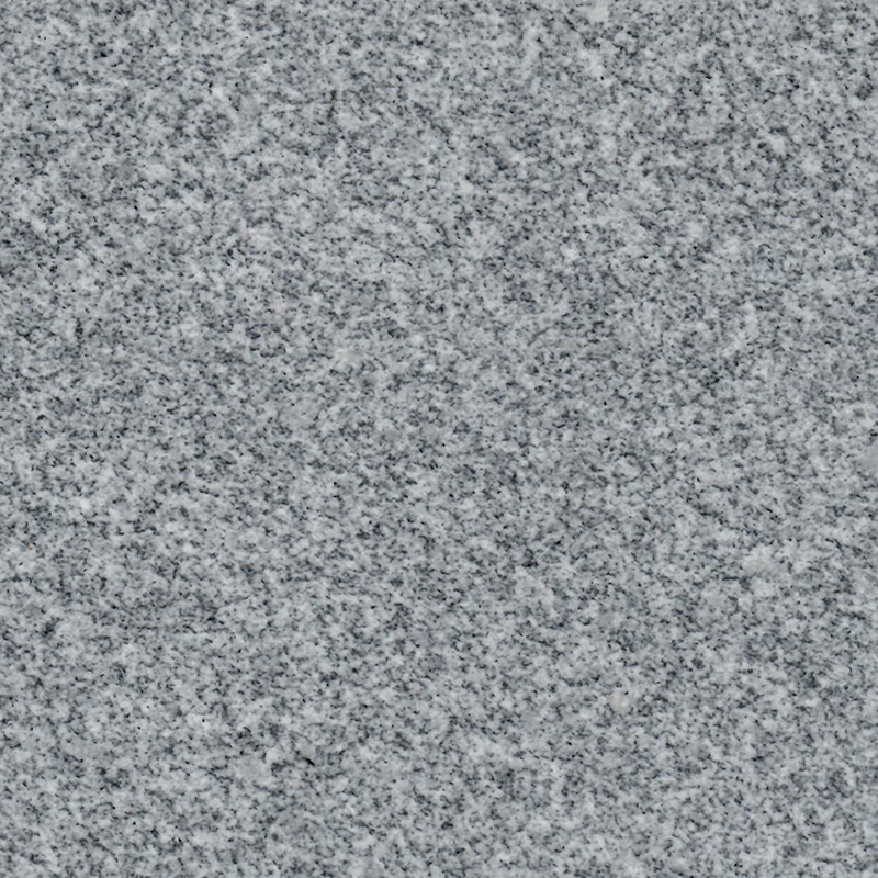 A detailed close-up of a speckled gray granite texture, showing various shades of light and dark gray flecks. This natural stone pattern is commonly used for headstones and other memorial products, offering a subtle and enduring background.