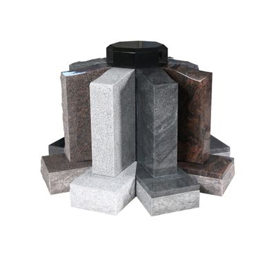 A circular display of various granite memorial stone samples, including light grey, dark grey, brown, and red granites, arranged around a central black capstone. The image highlights the different textures and natural color variations of the stones, suitable for headstones and monuments.